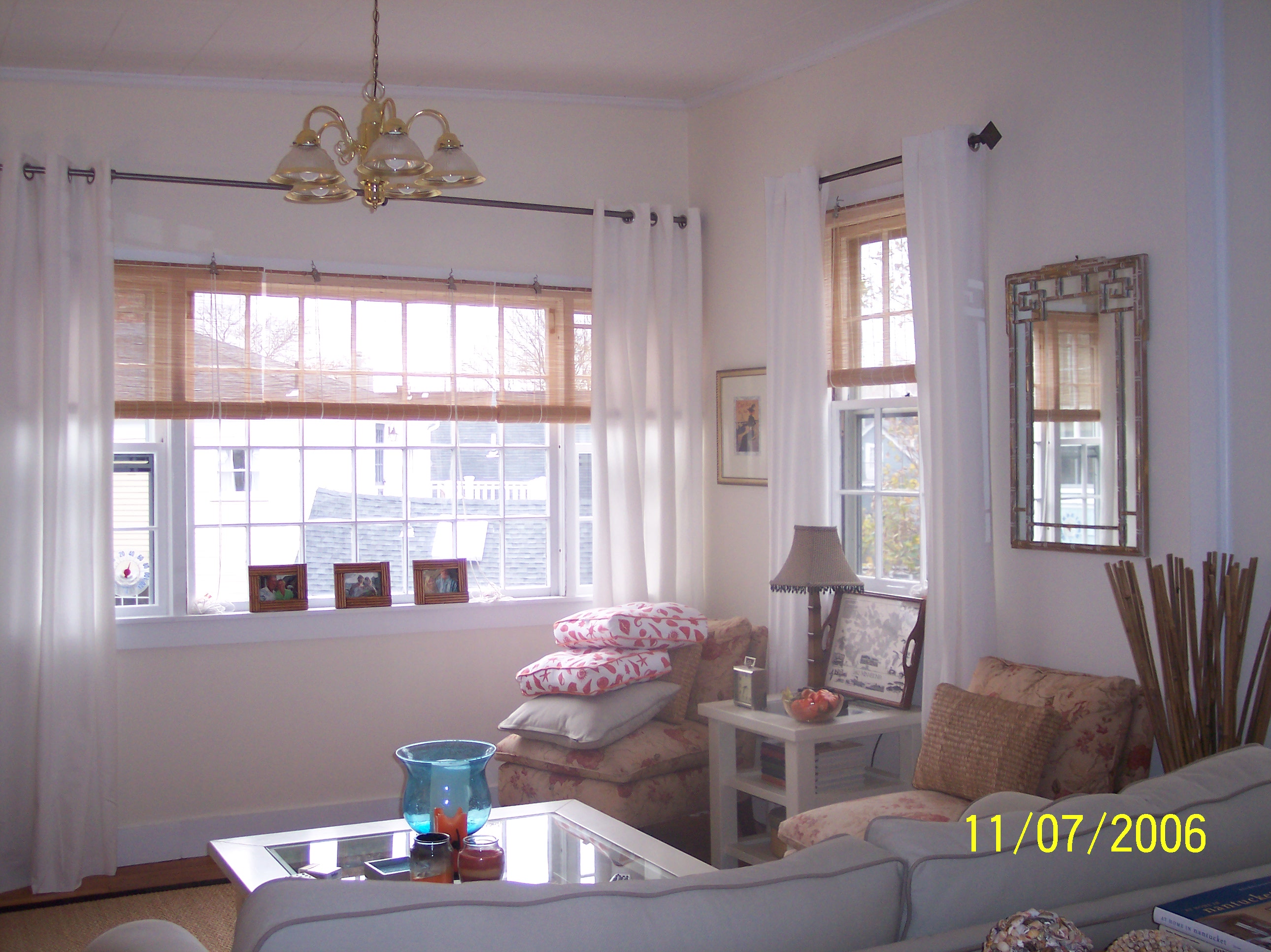 Living room with bamboo blinds, white linen drapes and coastal styling