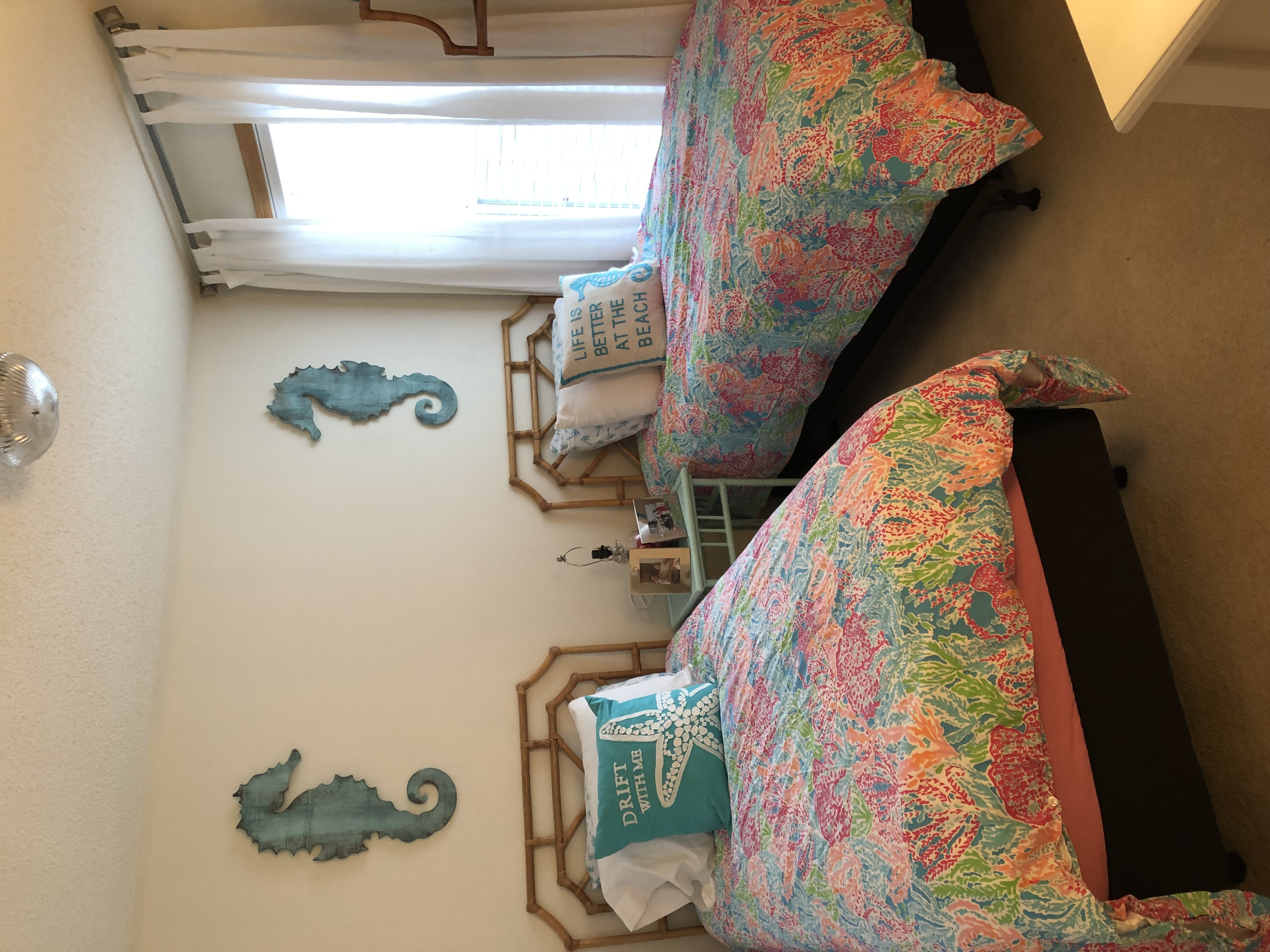 Coastal twin bedroom with seahorse wall art and Lilly Pulitzer bedding