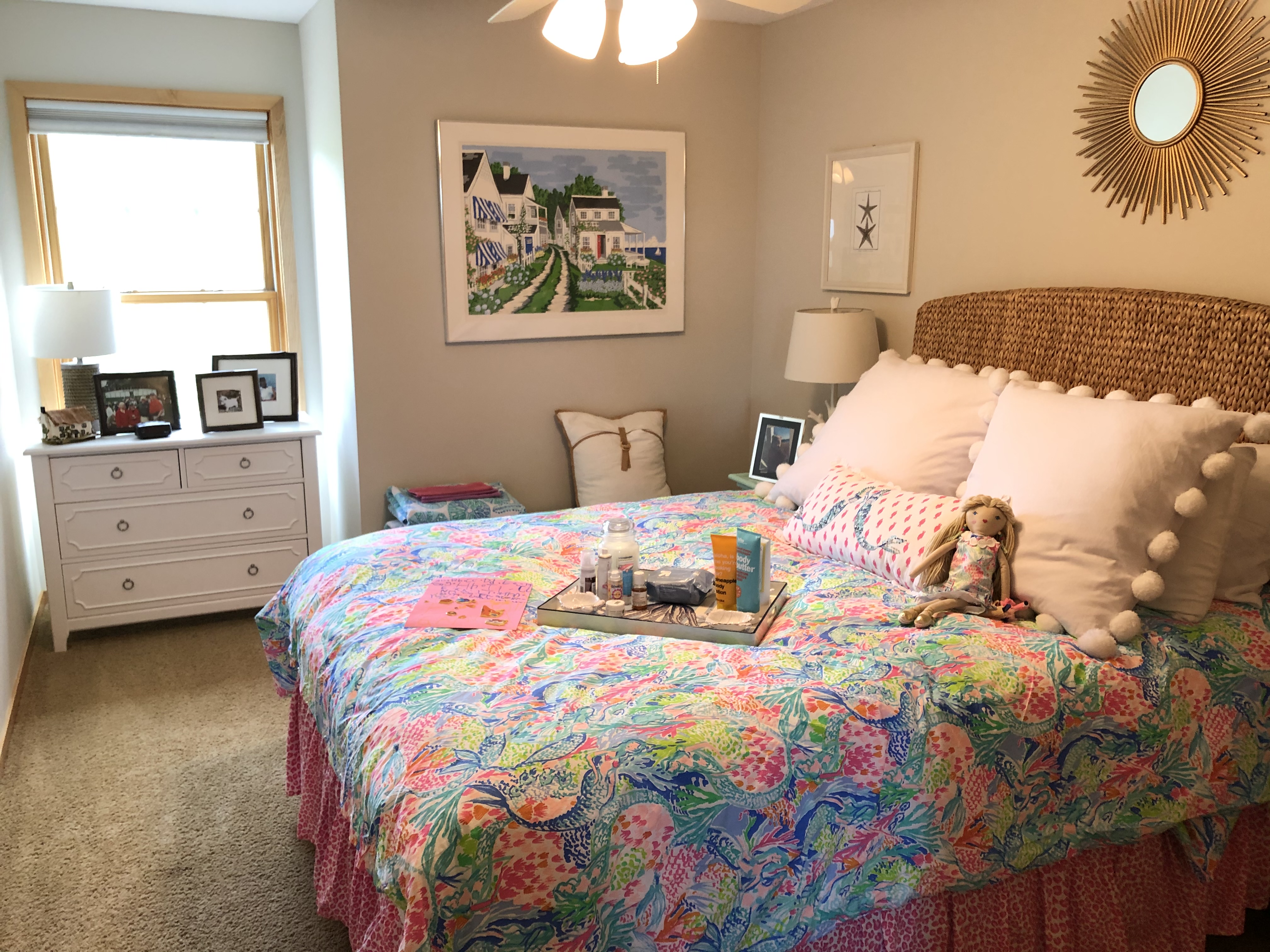 Bright coastal bedroom with Lilly Pulitzer bedding and seagrass headboard